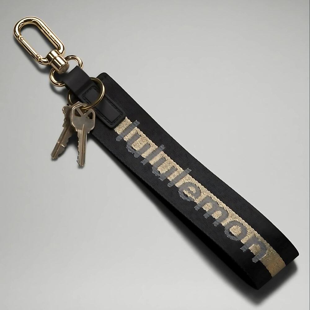 NEW Lululemon Never lost Keychain Wordmark Black and Gold